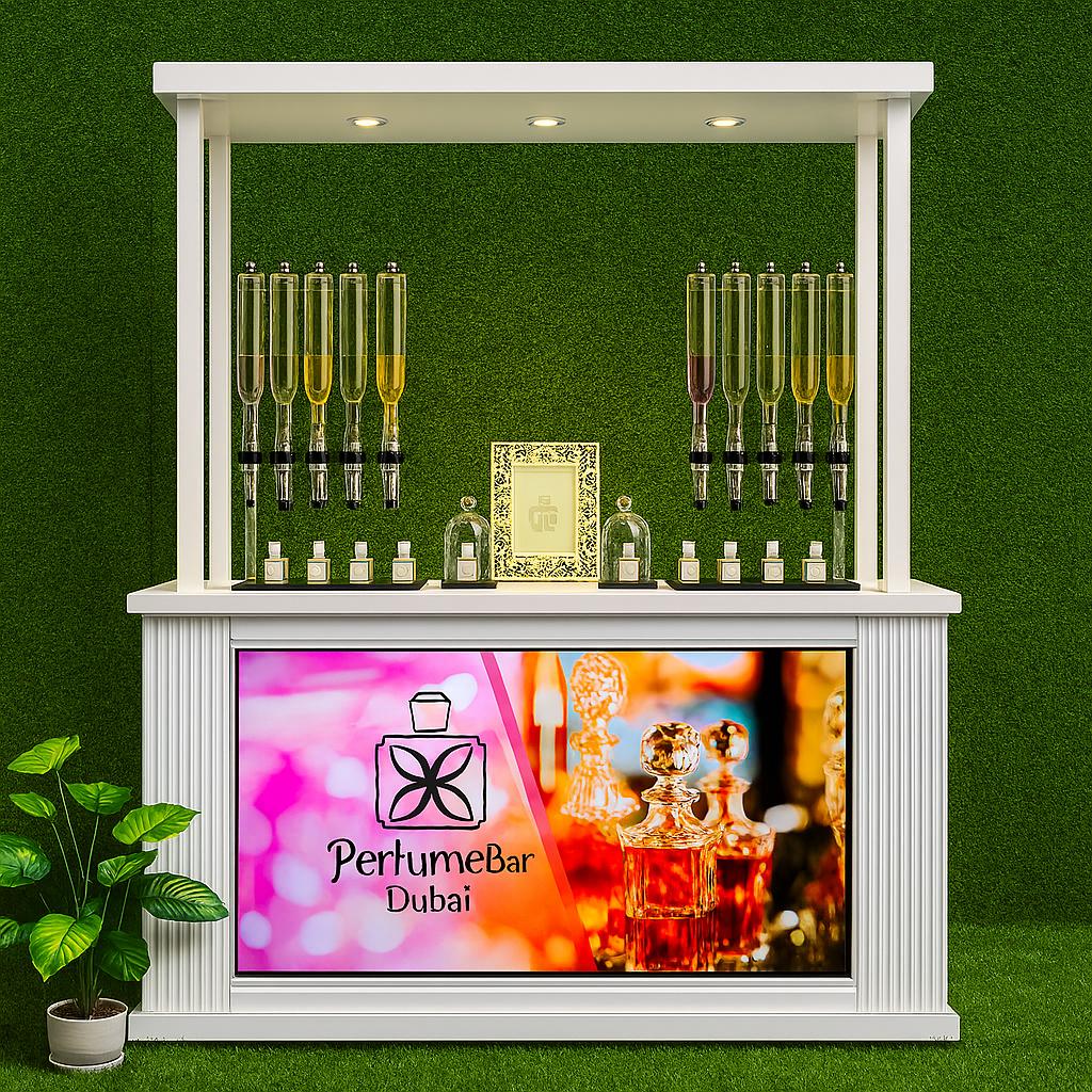 Perfume Booth setup in Dubai featuring a branded fragrance bar with colorful dispensers, interactive screen, and artificial grass backdrop for events and exhibitions